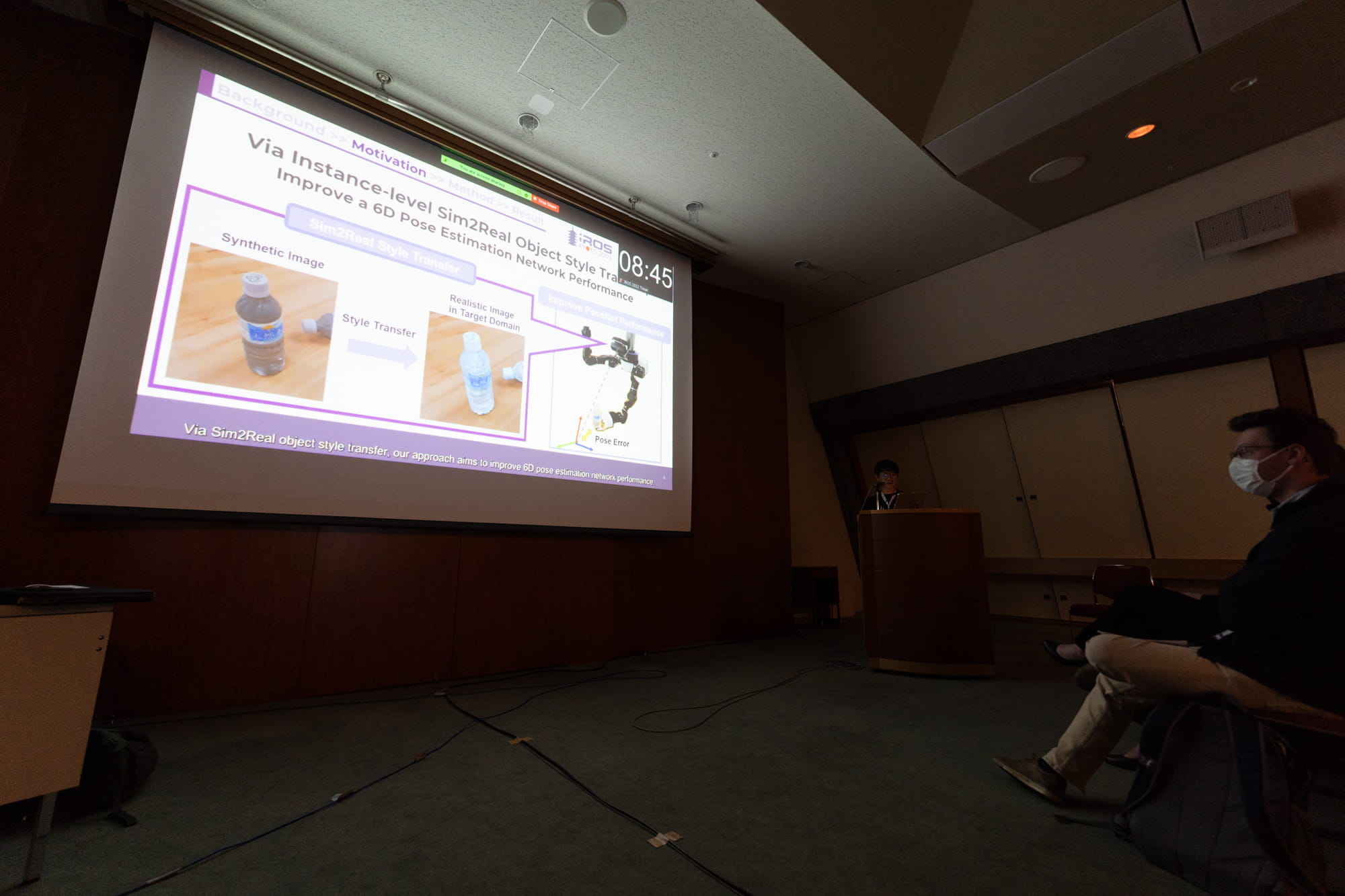 Photo of Ikeda giving a presentation during the technical session